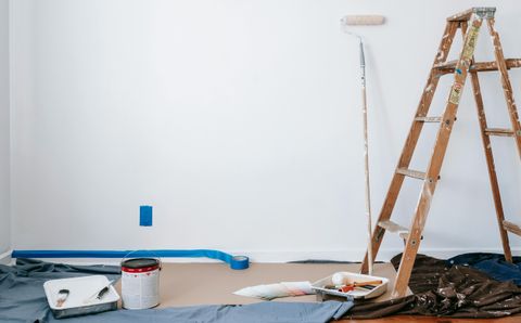 Freshly painted wall with painting tools